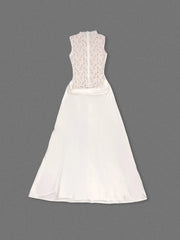 White dress with lace detailing on a gray background