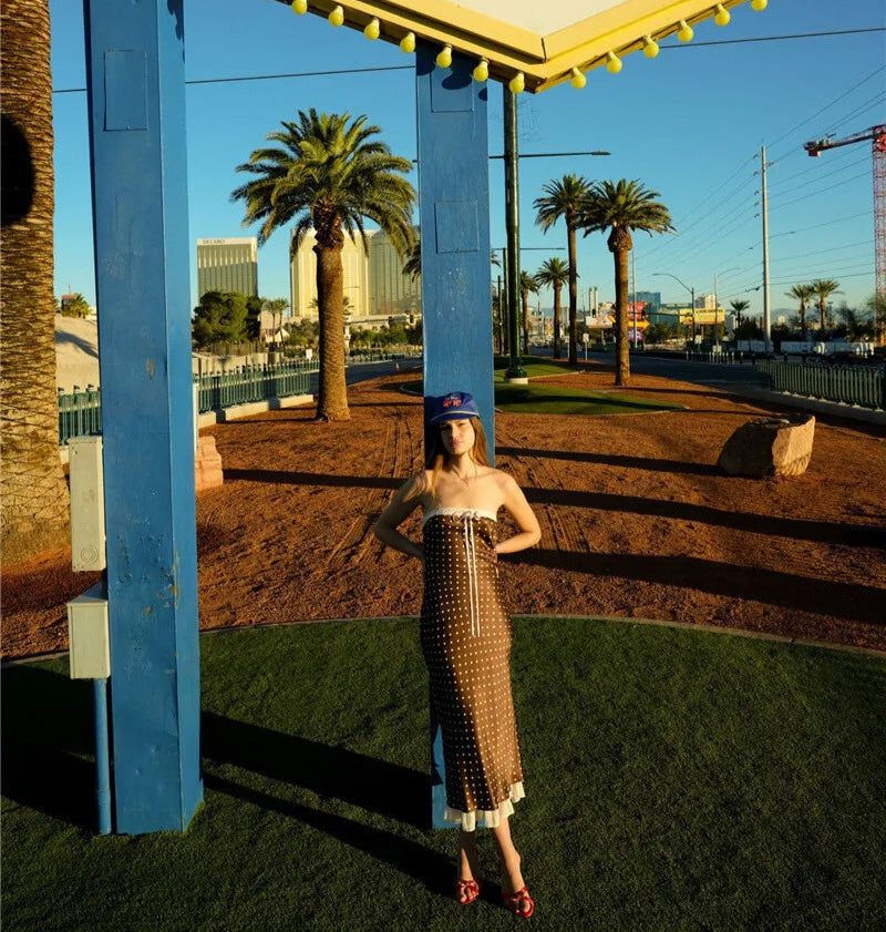 Vintage-style sign for Las Vegas, Nevada with a person in a dress standing underneath.