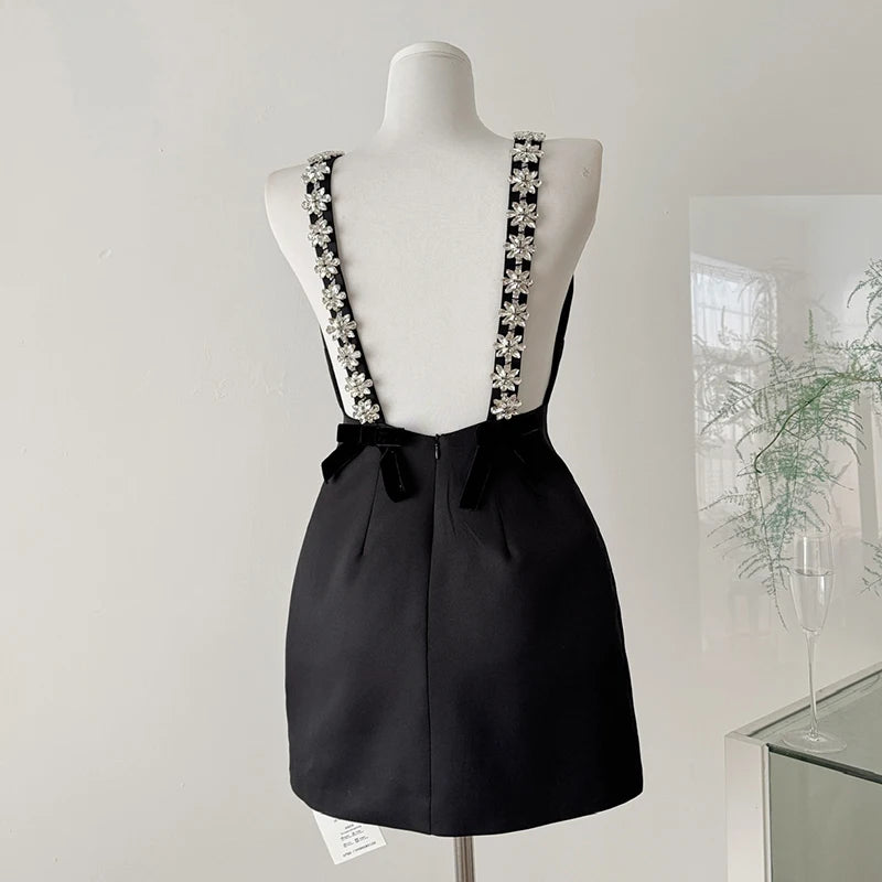 Black mini dress with crystal flower embellished spaghetti straps and velvet back bows
