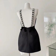 Black mini dress with crystal flower embellished spaghetti straps and velvet back bows