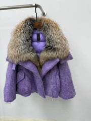 Purple coat with fur hood on a hanger against a white background