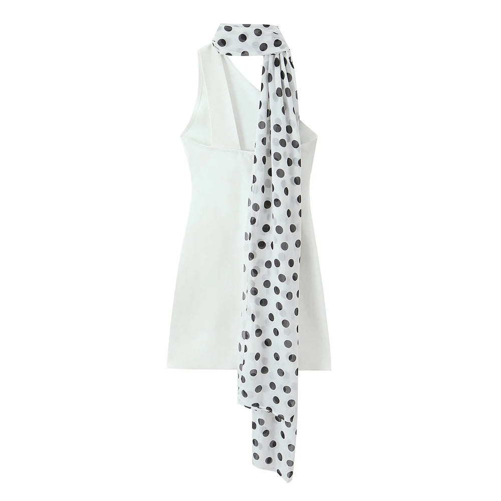 White sleeveless top with a polka dot scarf on a white background