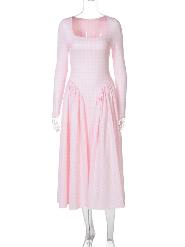 Pink dress on a mannequin against a white background