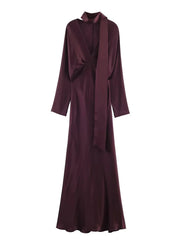 Maroon evening gown with a draped front on a white background