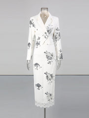 White dress with floral patterns on a mannequin against a gray background