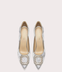 Pair of silver high-heeled shoes with intricate patterns on a white background