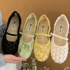 Close-up of four floral mesh Mary Jane flat shoes