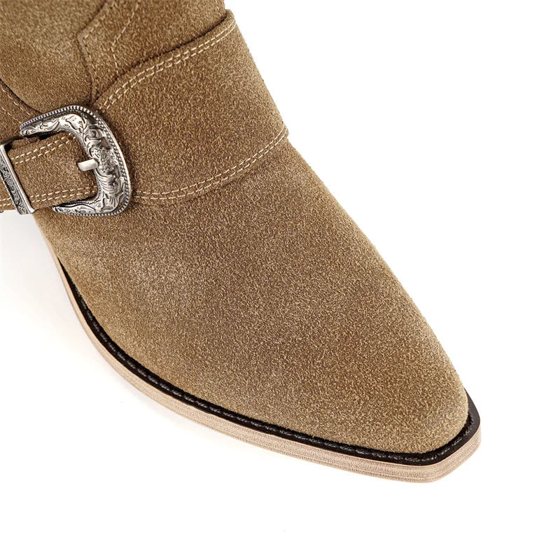 Close-up of the pointed toe and buckle detail on suede boots