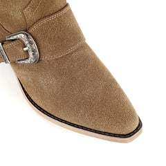 Close-up of the pointed toe and buckle detail on suede boots
