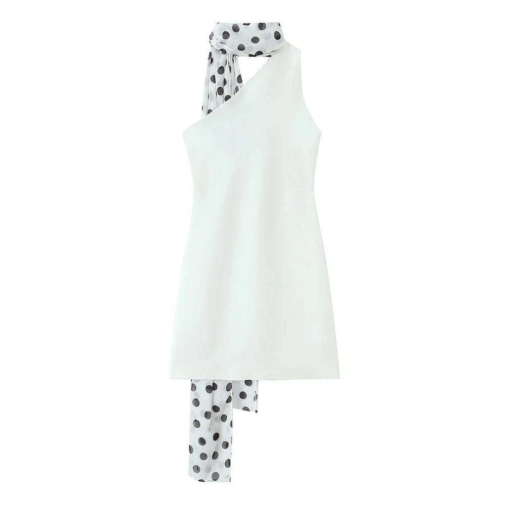 White sleeveless top and polka dot pants on a white background