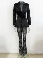 Black pearl embellished cutout blazer and beaded flare pants suit on mannequin
