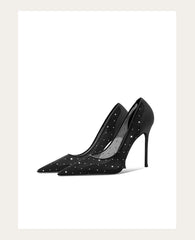 Black high-heeled shoes with star patterns on a white background