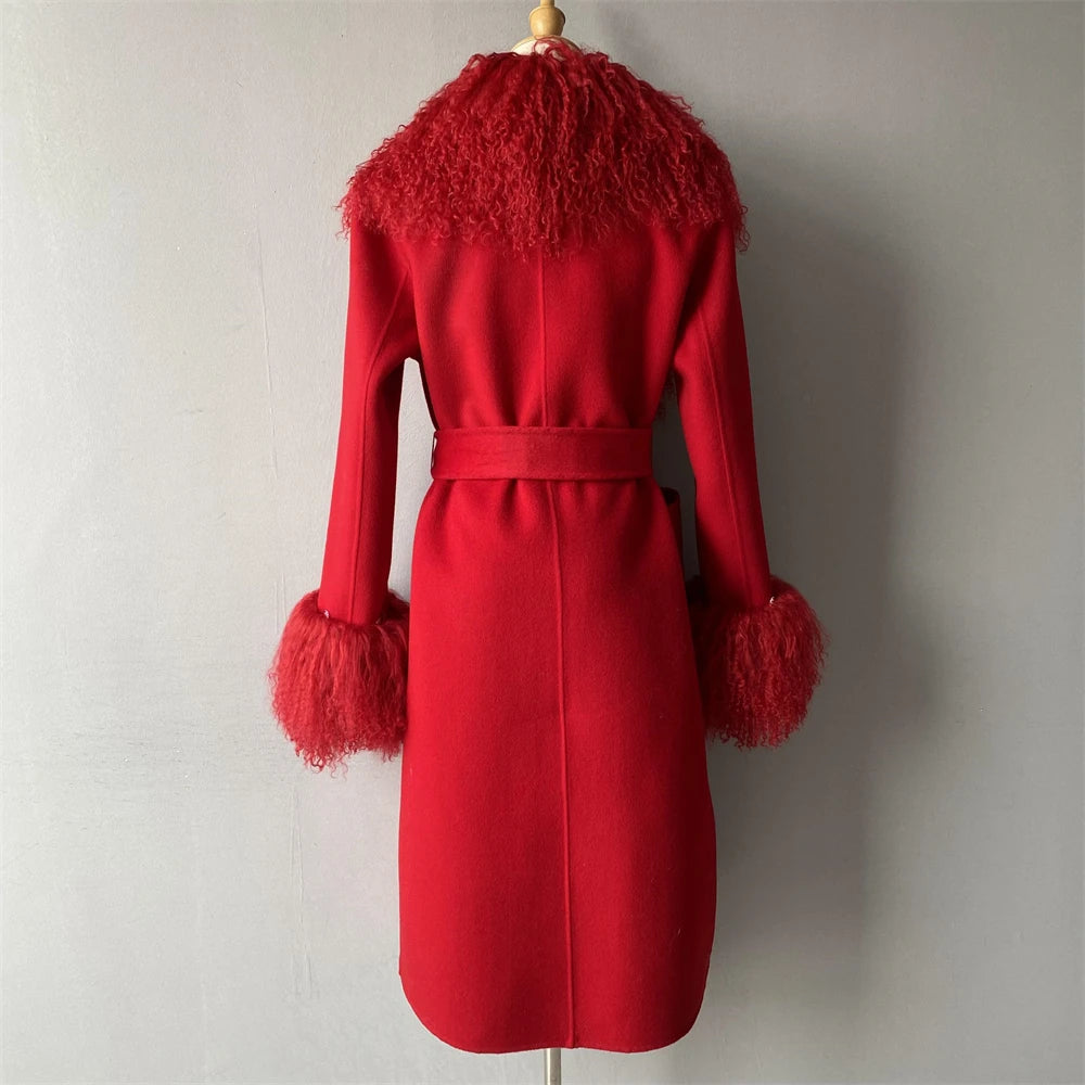 Red coat with feathered collar and cuffs on a mannequin against a plain background