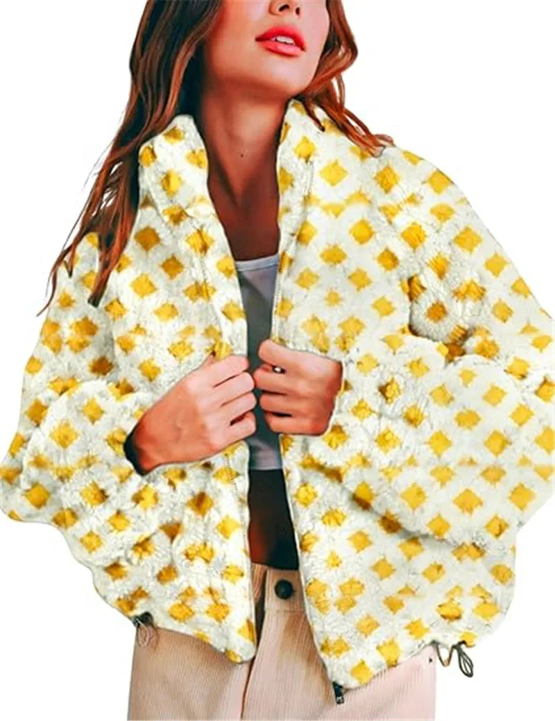 Woman wearing a yellow and white patterned poncho against a white background