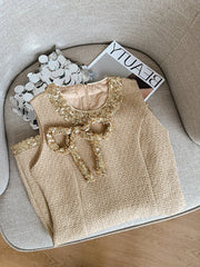 Beige textured top with decorative bow on a round surface