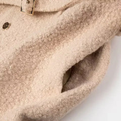 Close-up of a beige textured fabric with a buckle