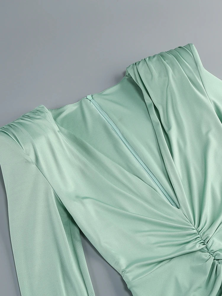 Light green dress with a knot detail on a gray background