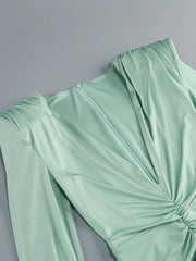 Light green dress with a knot detail on a gray background