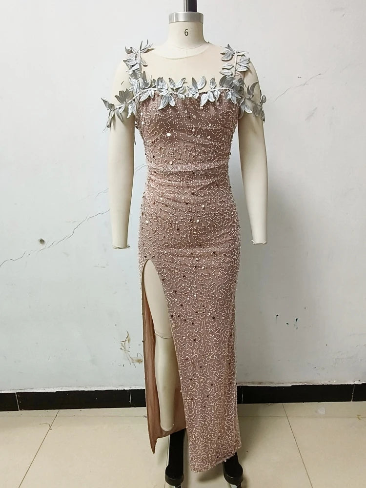 Brown evening gown with floral shoulder details on a mannequin against a white wall.