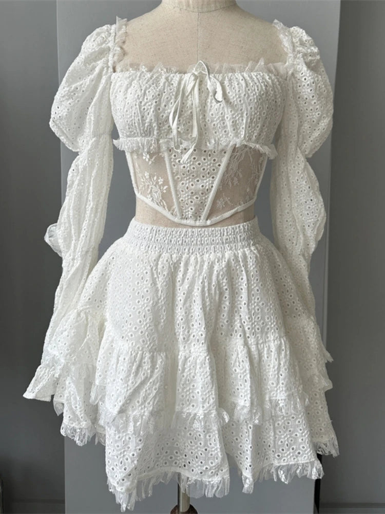 White lace dress on a mannequin against a gray background