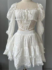 White lace dress on a mannequin against a gray background