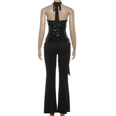 Black sequin top and black pants on a mannequin against a white background