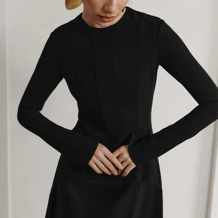 Person wearing a black long-sleeve dress