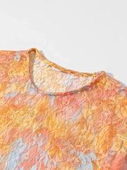 Close-up of a textured fabric with orange and gray patterns on a light gray background