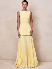 Boat neck sleeveless dress with a floor-length pleated skirt in yellow.