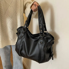 Black tote bag with rivet details and twin top handles