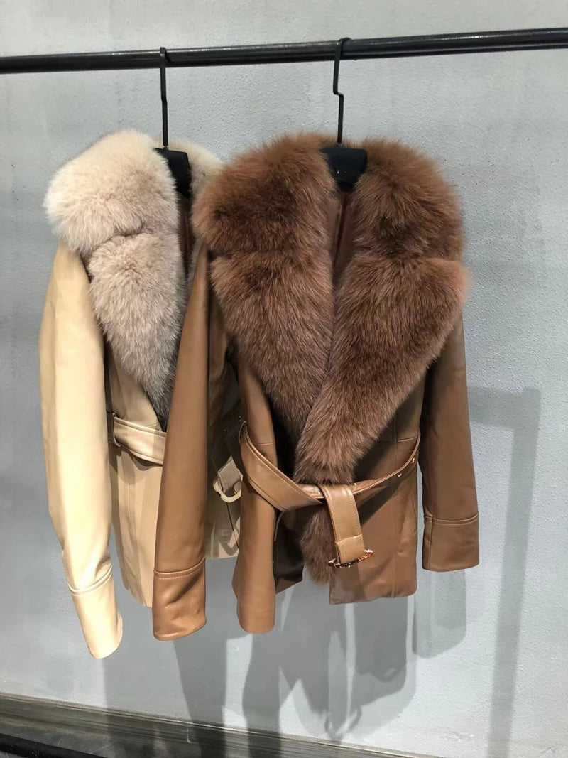 Two leather jackets with fur collars on a rack against a gray background