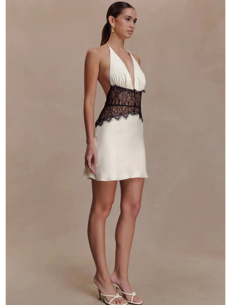 Elegant white mini dress styled with contrasting lace detail