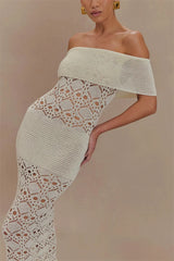 Woman wearing a white off-shoulder crochet dress against a beige background