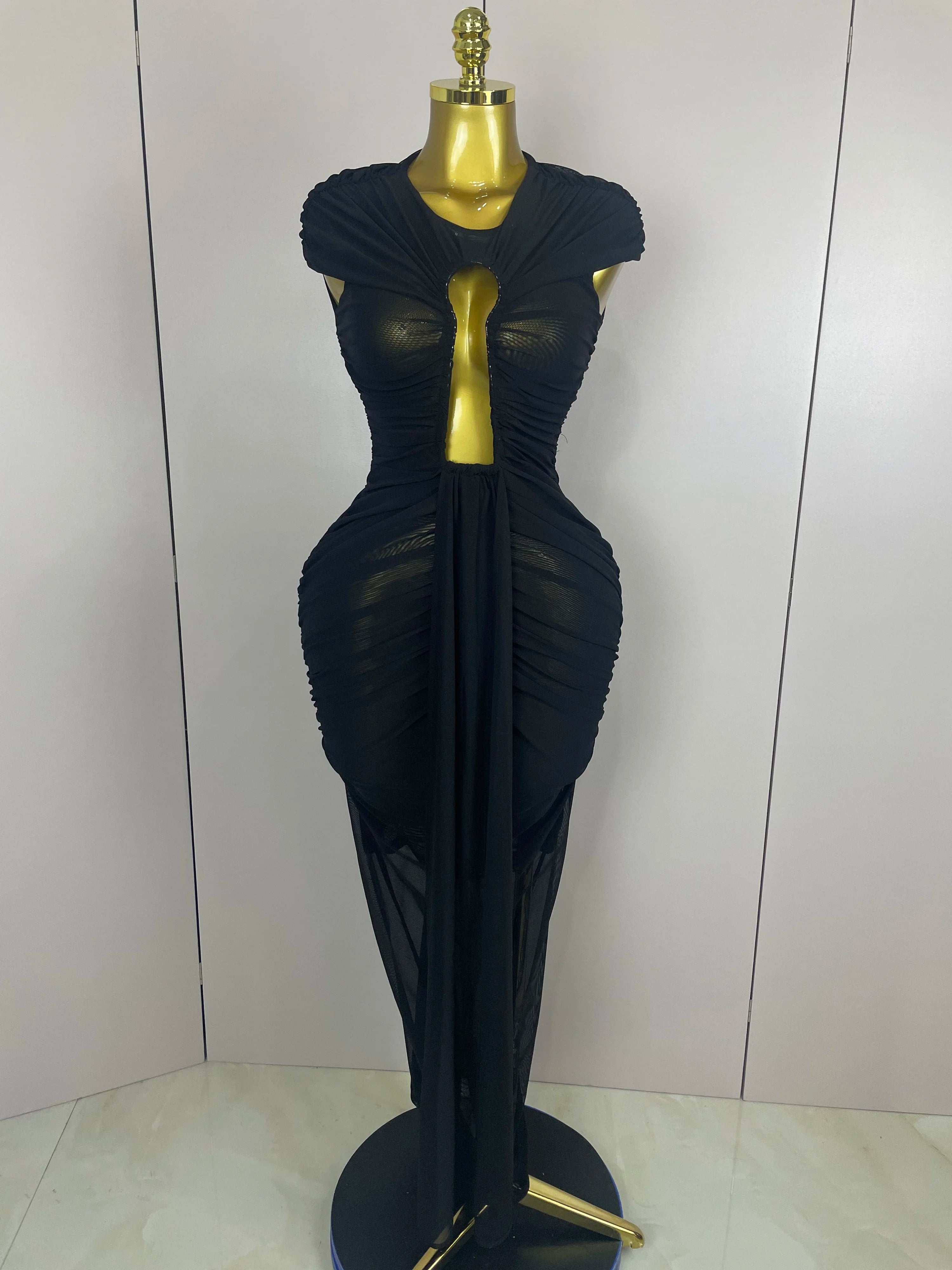 Black evening gown on a mannequin against a white background