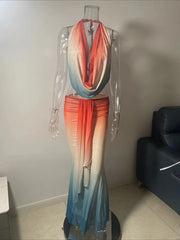 Mannequin wearing a colorful dress with an ombre effect in a room setting.