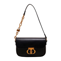 Black handbag with gold chain strap and clasp on a white background