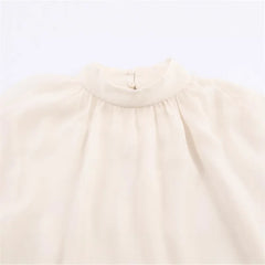 Beige blouse with a collar on a light gray background