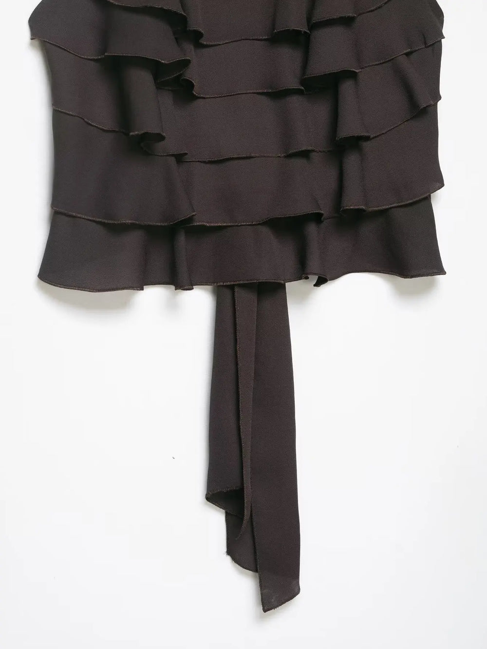 Dark brown strapless dress with ruffled layers on a white background