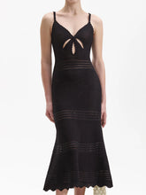 Black knit midi dress with a V-neck cutout and fishtail hem