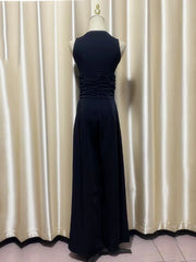 Navy blue evening outfit on a mannequin against a beige curtain background