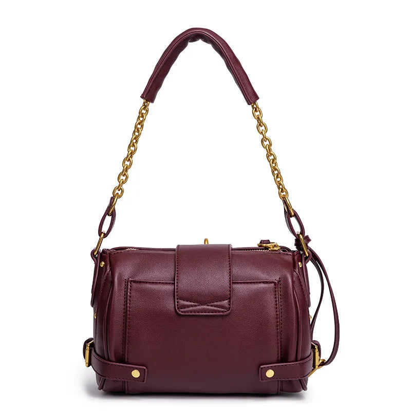 Back view of a burgundy leather shoulder bag with a flap closure detail.