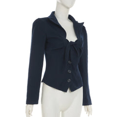 Navy blue top with a bow detail on a mannequin against a white background