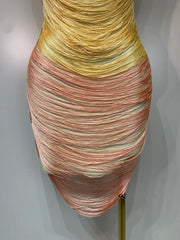Multicolored dress on a mannequin against a plain background