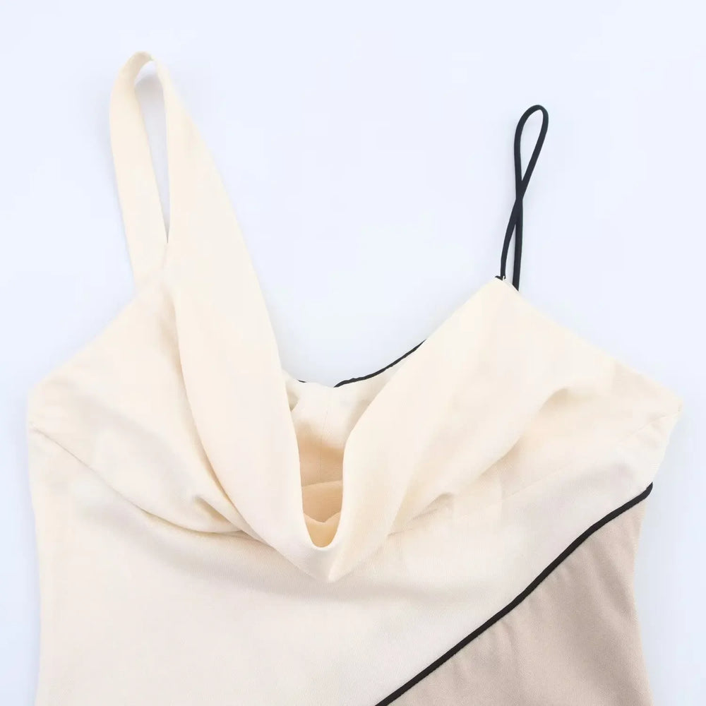 Cream-colored top with black trim on a white background