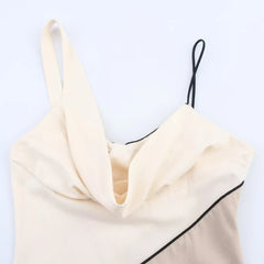 Cream-colored top with black trim on a white background