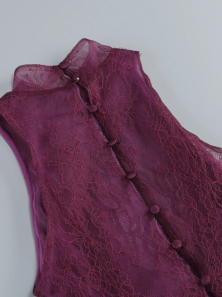 Close-up of a purple lace garment with buttons on a light gray background