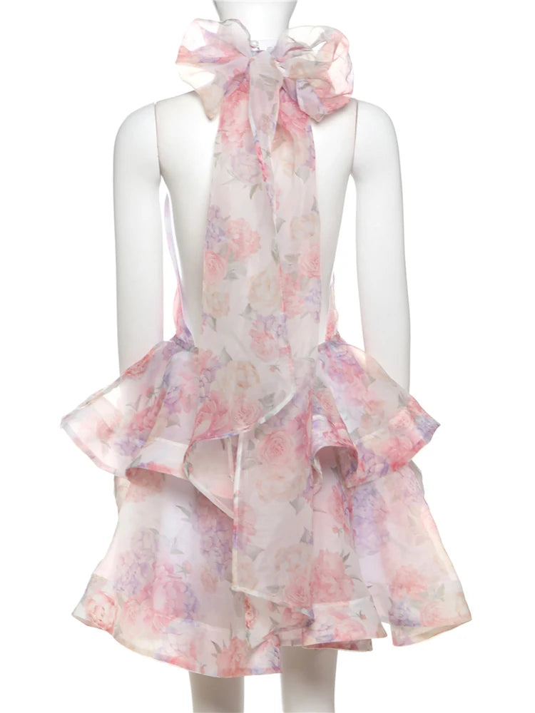 Mannequin wearing a floral dress with a matching scarf on a white background