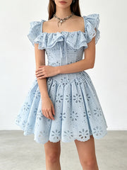 Model wearing the off-the-shoulder ruffled eyelet mini dress