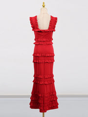 Red ruffled dress on a mannequin against a white background
