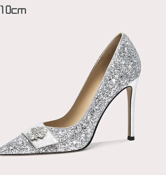 Silver glitter high-heeled shoe with a decorative bow on a white background
